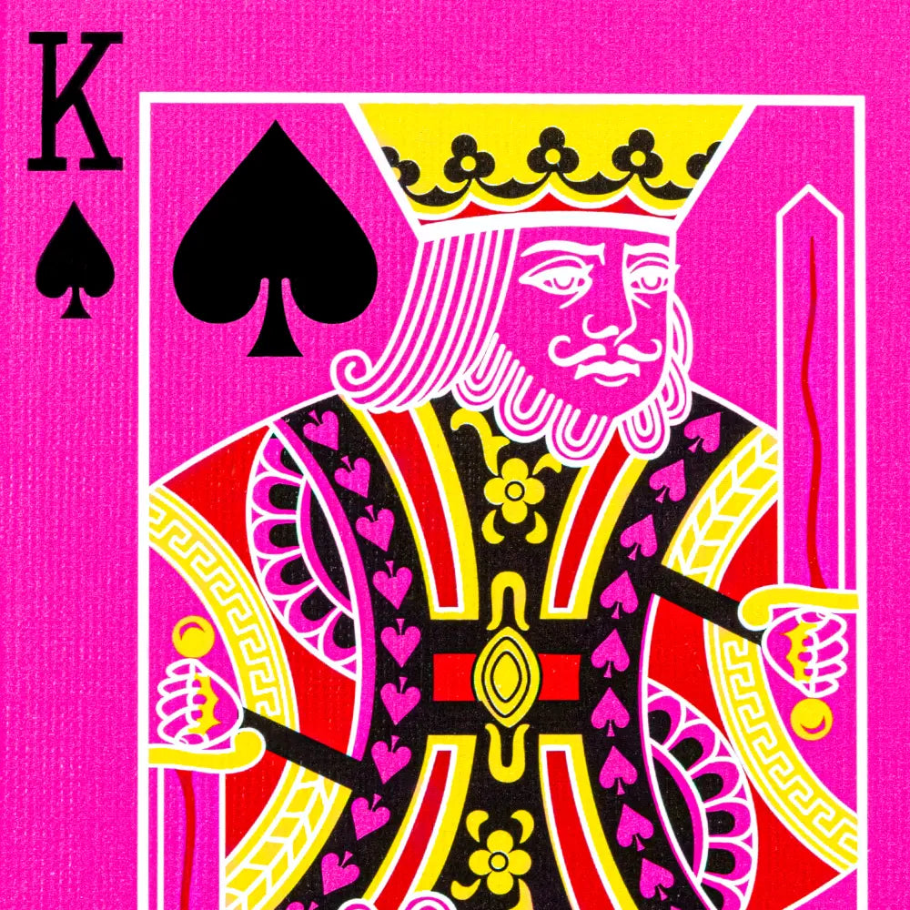 Close up King of Spades face card from pink bicycle playing cards deck by Magic Makers Inc in vivid magenta